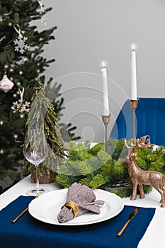 Festive place setting with beautiful dishware, cutlery and fabric napkin for Christmas dinner on white table