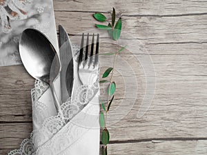 Festive place setting for christmas dinner. Vintage cutlery on the white napkin and fir cone, holiday dinner symbol, winter