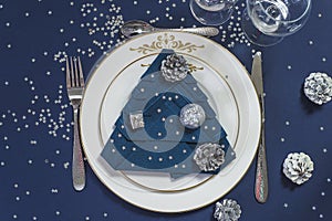 Festive place setting for Christmas or New year holiday dinner.