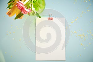 Festive postcard mock up on blue background with flowers. Top view. 1st of September and back to school mock up concept