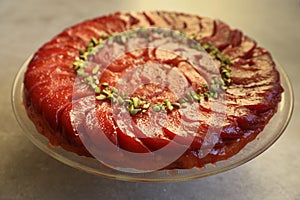 Festive Quince tart tatin, beautiful and delicious  dessert for the Holidays, garnished with green pistachios