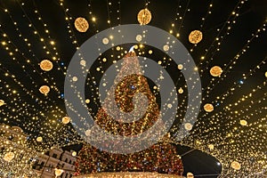 Festive Radiance: Christmas Tree Illuminated with Golden Lights