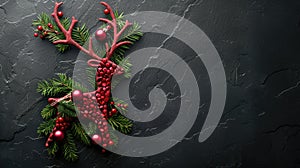 Festive Reindeer made of Fir Branches and Red Baubles on a Black Stone for Christmas Concept