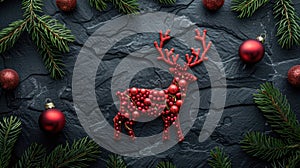 Festive Reindeer made of Fir Branches and Red Baubles on a Black Stone for Christmas Concept