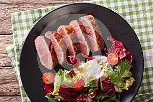 Festive roast duck breast and fresh mix green salad close-up. Ho