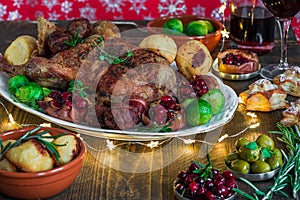 Festive roast duck on wooden table with brussel sprouts, baked p