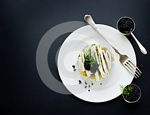 Festive salad with black caviar, gourmet restaurant food