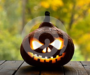 Festive scary halloween pumpkin on wooden table