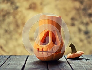 Festive scary halloween pumpkin on wooden table