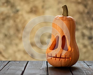 Festive scary halloween pumpkin on wooden table