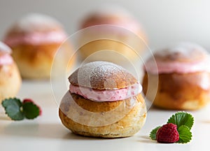 Festive Semlor or Semla : Traditional Scandinavian Buns flavored with cardamom filled with almond paste & raspberry whipped cream