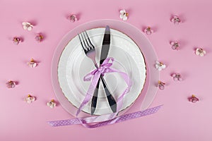 Festive set of cutlery knife and fork with a white dessert plate