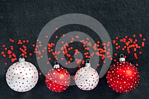 Festive set of white and red  new year toys balls on black background. Christmas banner, winter decoration
