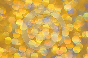 Festive shiny abstract background of textured twinkling yellow gold.