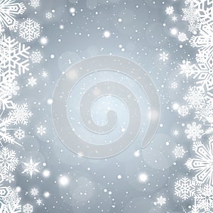 Festive silver bokeh background with a border of white snowflakes