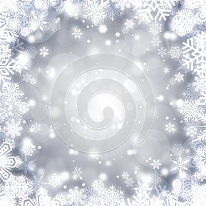 Festive silver bokeh background with a frame of shiny white snowflakes