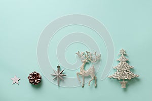 Festive silver dear, stars, fir-tree, cone on blue background with copy space. Christmas and new year party. Minimal concept. Flat