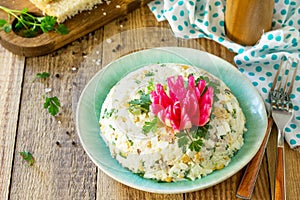 Festive snack on Easter table. Salad with Rice, Onion, Egg, Corn and Mushrooms
