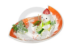 A festive snack of eggs and vegetables, decorated in the form of a snowman on skis. Christmas and New Year concept.