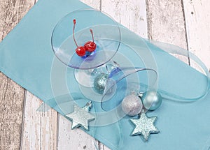 Festive spirit blue martini cocktail glasses on shabby chic table