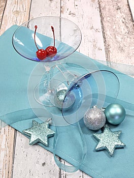 Festive spirit blue martini cocktail glasses on shabby chic - vertical