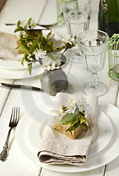 Festive spring table setting with pear blossom flowers