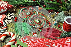 Festive still life with hand crafted macrame dreamcatchers and knitted mittens