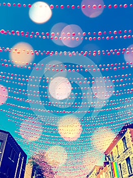 Festive street in gay neighborhood decorated with pink balls