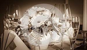 Festive table arrangement with glasses and served and flowers