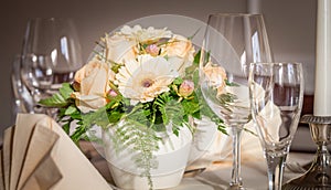 Festive table arrangement with glasses and served and flowers