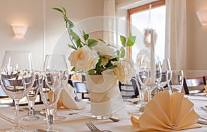 Festive table arrangement with glasses and served and flowers