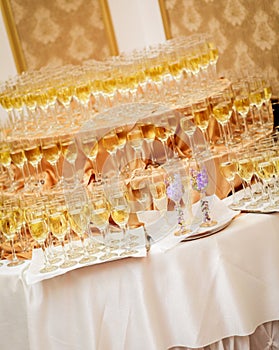 Festive table at a banquet of the wedding - champagne glasses