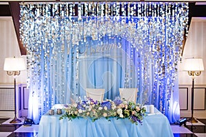 Festive table for the bride and groom decorated in a luxury style with glosses. With inscription Dream come true