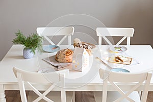 Festive table in a bright living room with fragrant homemade bread