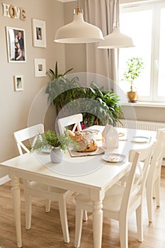 Festive table in a bright living room with fragrant homemade bread