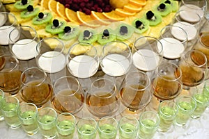 Festive table with cold exotic alcoholic beverages, cocktails and fruits.