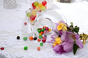 A festive table decorated with birthday cake with flowers and sweets.