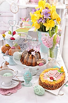 Festive table decoration with traditional easter pastries and co