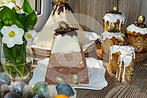 Festive table for Easter. A lot of Easter cakes from curd dough decorated with chocolate and chocolate quail eggs,