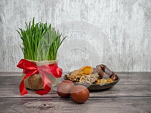 Festive table in honor of Navruz. Wheat with a red ribbon, the traditional holiday of the vernal equinox Nawruz