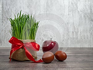 Festive table in honor of Navruz. Wheat with a red ribbon, the traditional holiday of the vernal equinox Nawruz