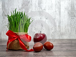 Festive table in honor of Navruz. Wheat with a red ribbon, the traditional holiday of the vernal equinox Nawruz