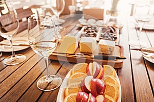 table served with delicious snacks - fruits, various cheeses and olives - at the winery. Ready for winetasting tour photo