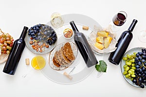 Festive table served with red wine and Mediterranean food appetizer snack on white background. Wine party event dinner