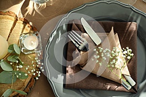 Festive table setting with beautiful tableware, candle and floral decor, flat lay