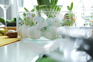 Festive table setting with Easter decorative eggs in bowl