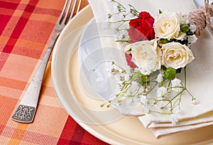 Festive table setting with flowers and vintage crockery