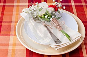 Festive table setting with flowers and vintage crockery