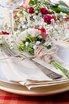 Festive table setting with flowers and vintage crockery, closeup