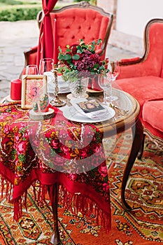 Festive table setting in national Russian style. Red color in decor and decoration of event.